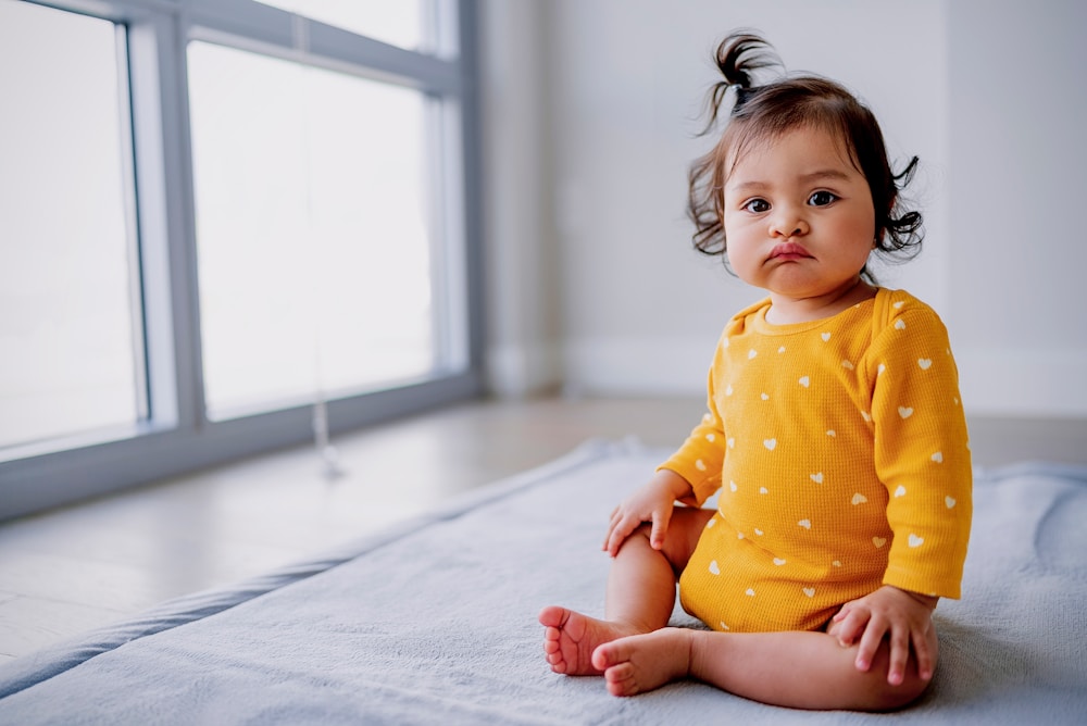 Smiling baby on a rug at home