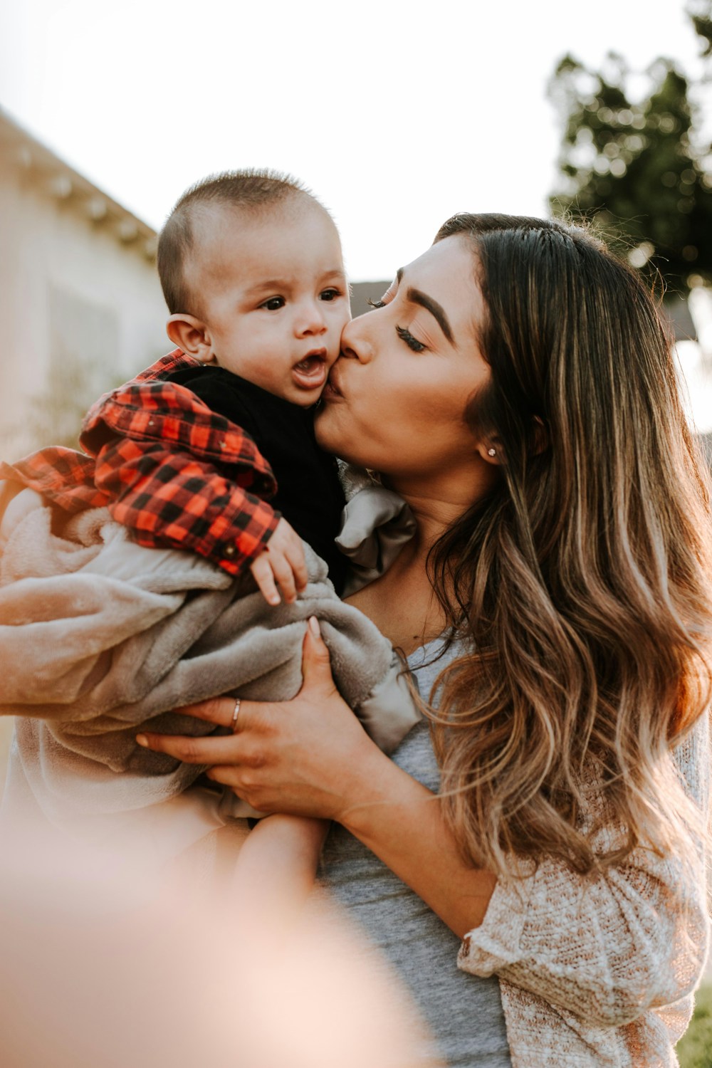 Parent holding her infant close at home
