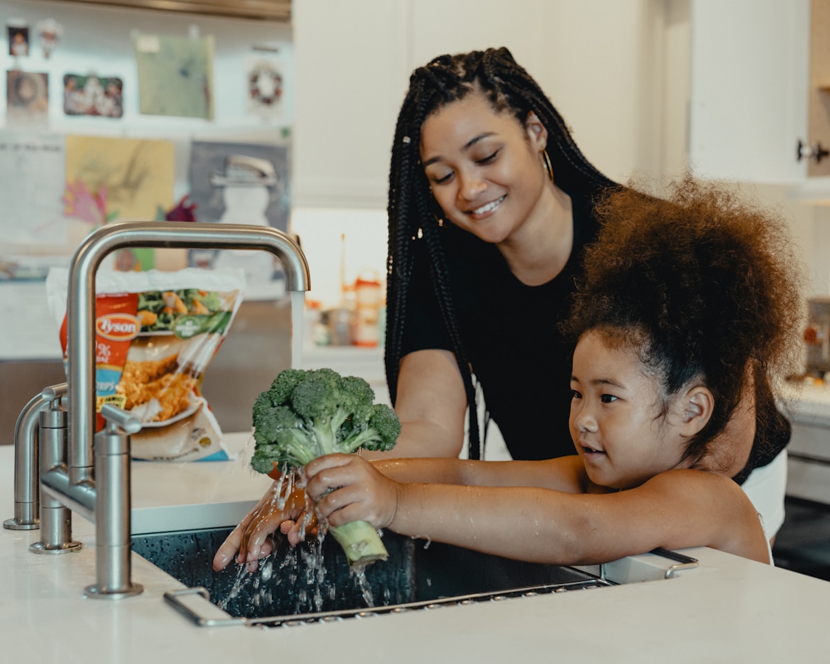 A parent smiling with her toddler at home